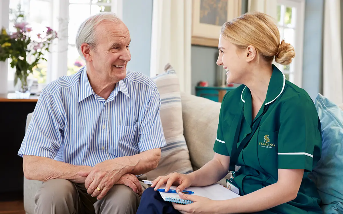 Smiling Starling Homecare care worker spending time with elderly man at home Smiling Starling Homecare care worker spending time with elderly man at home