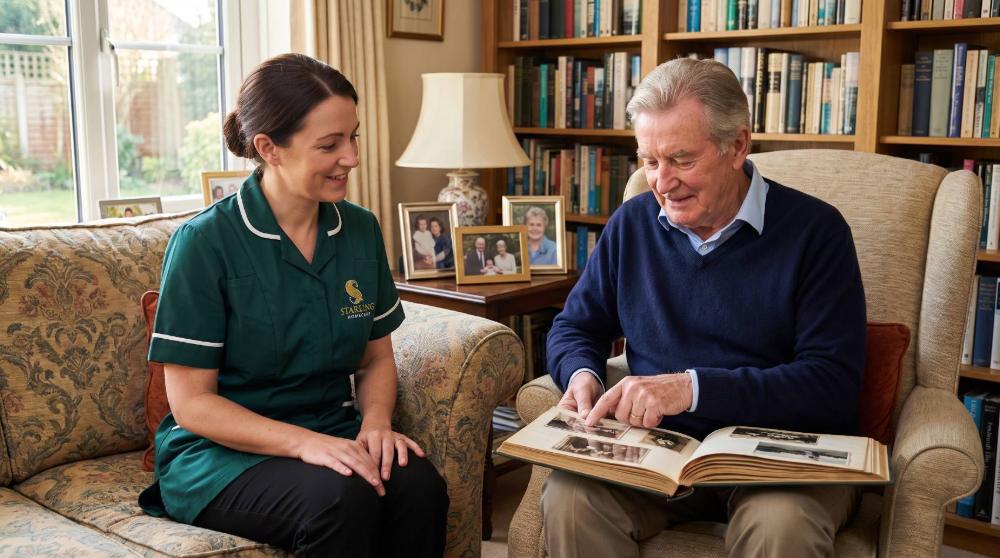 A Starling Homecare carer sits with an older man in Hemel Hempstead, looking through a photograph album together at home.