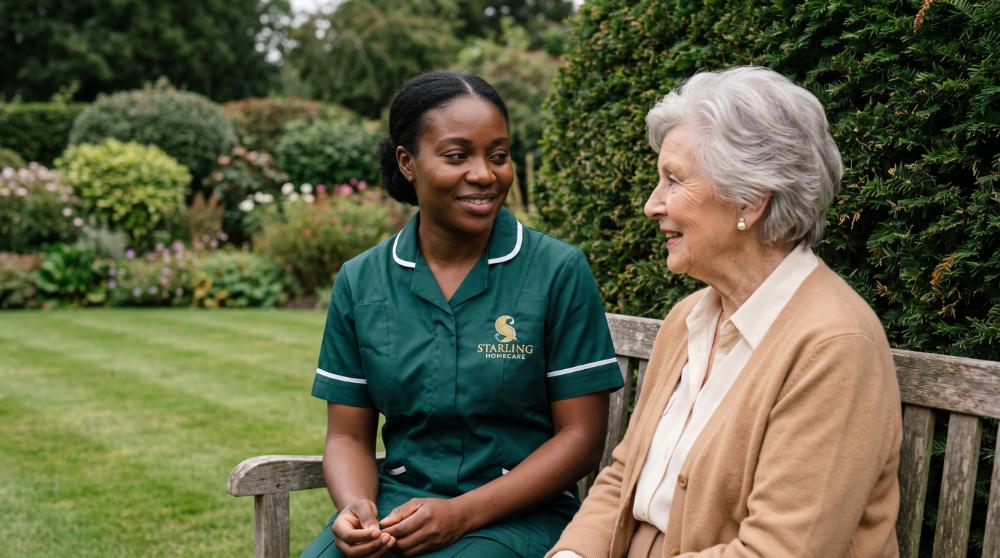 deputyship-hertfordshire-carer-garden-bench A Starling Homecare carer talking with an older woman on a garden bench, care arranged under a deputyship in Hertfordshire