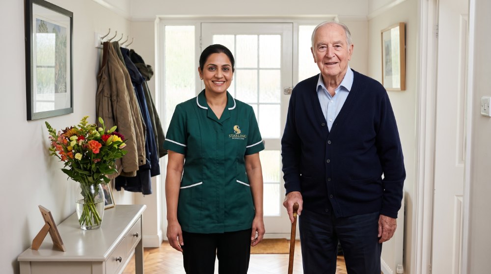 Home care after hospital in Potters Bar A Starling Homecare carer welcoming an older man back into his hallway on the first morning of his home care after hospital in Potters Bar