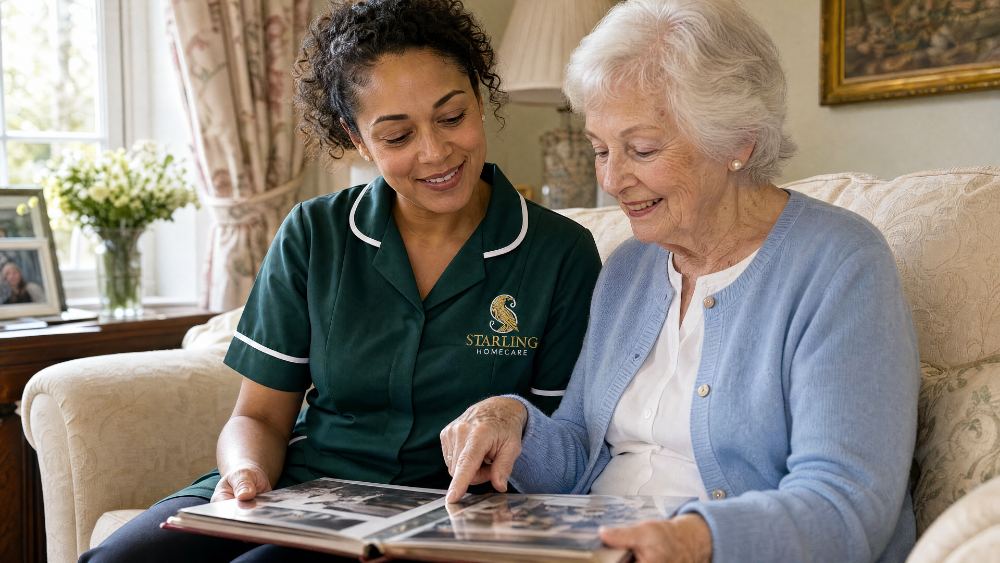 A Starling Homecare carer looking through a photo album with an older woman at home, dementia support in Redbourn